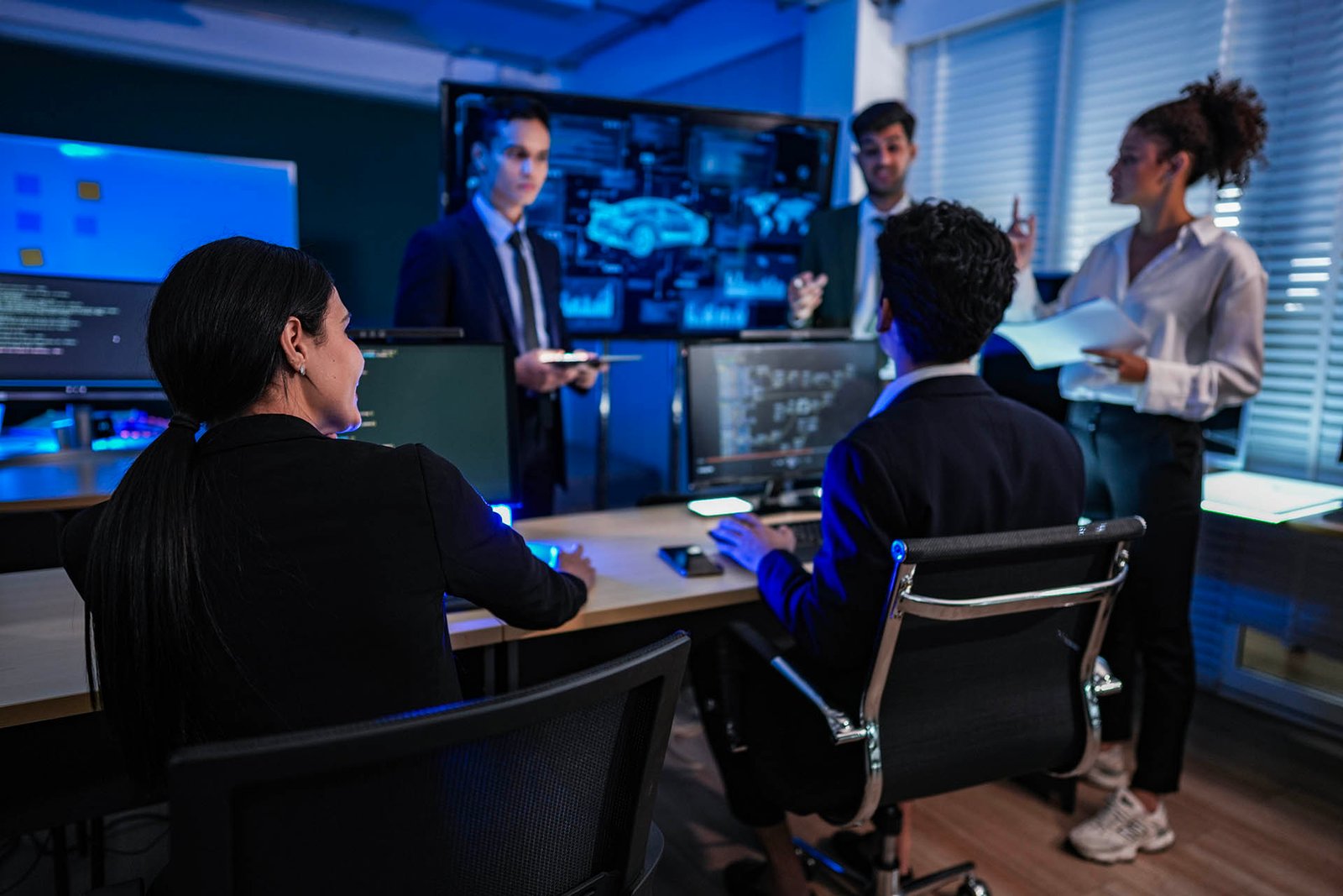 Strategic team meeting in an office command center, reviewing au